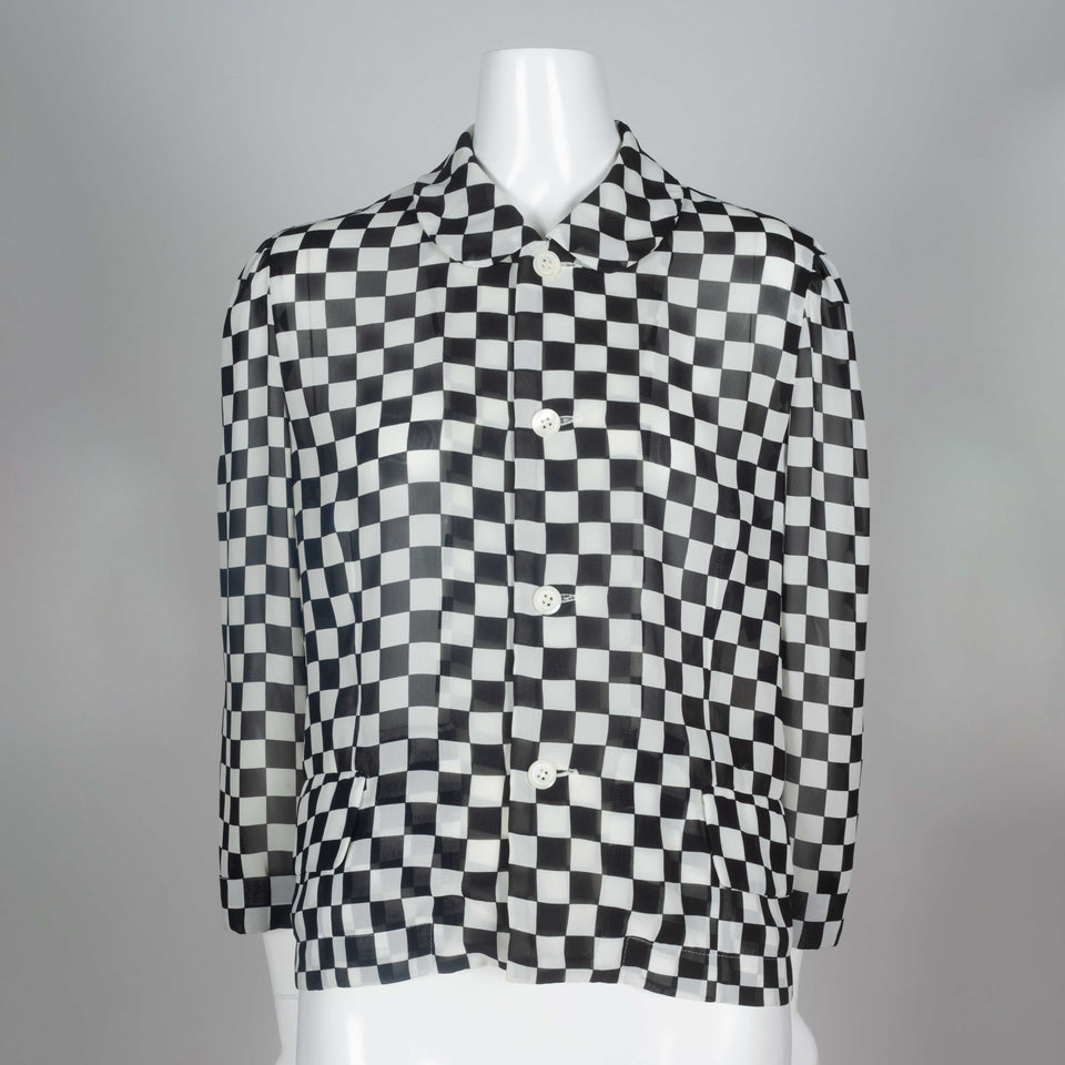 A 1996 chiffon long sleeve blouse from Japan by Comme des Garçons with black and white checkered print and peter pan collar.