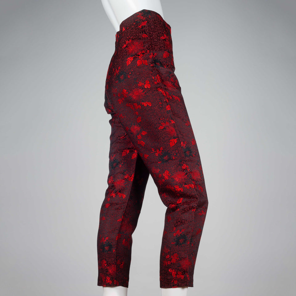 Comme des Garçons 1991 black trousers with bright red all-over flower and leaf embroidery.