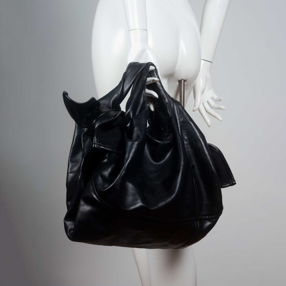 Comme des Garçons black purse from Japan in soft synthetic leather.