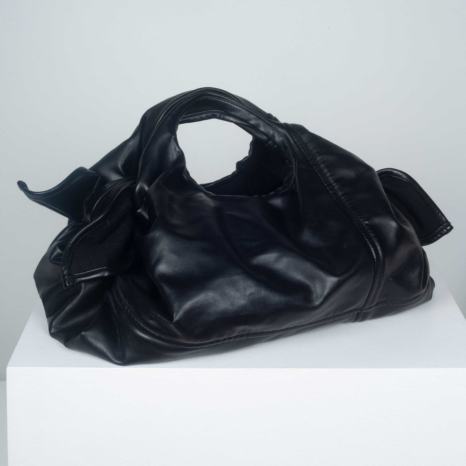 Comme des Garçons black purse from Japan in soft synthetic leather.