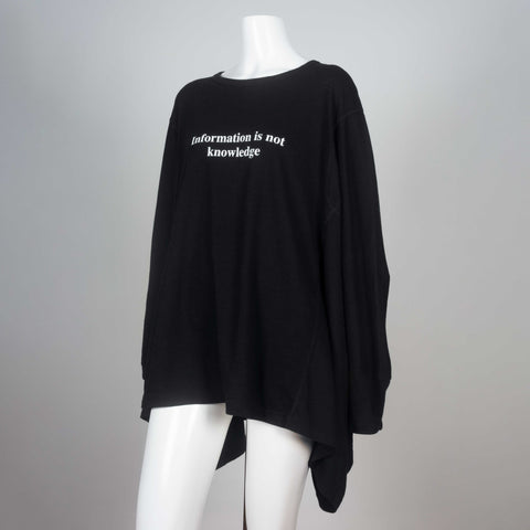 Kimono sleeved black t-shirt from Japan with visible surge stitching and a message in white lettering, "Information is not knowledge."