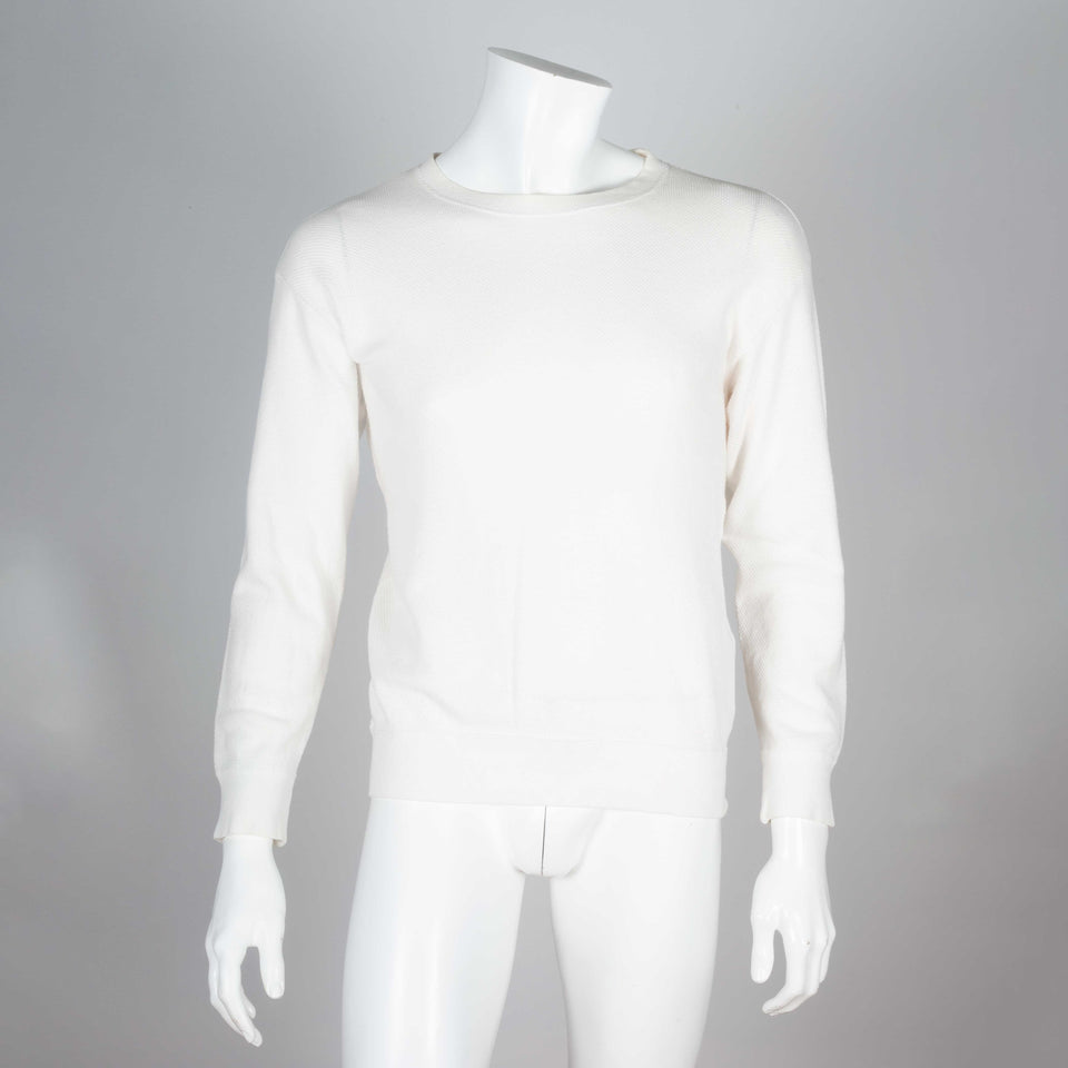 Comme des Garçons Homme 1989, a white long sleeve knit shirt with brand text on back.