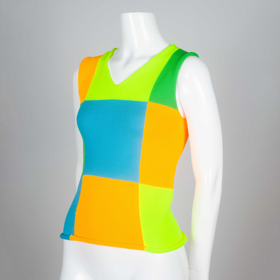 A 1995 neon color block knit sleeveless top from Japan by Comme des Garçons.