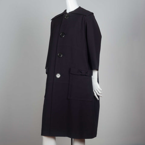 Comme des Garçons Tricot 2017 navy blue single-breasted coat with wide collar, large button and snap button pockets with bows.