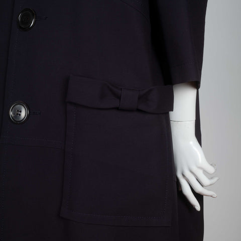 Comme des Garçons Tricot 2017 navy blue single-breasted coat with wide collar, large button and snap button pockets with bows.