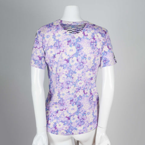 A purple vintage Comme des Garçons floral t-shirt with black geometrical pattern screen printed on the front. 
