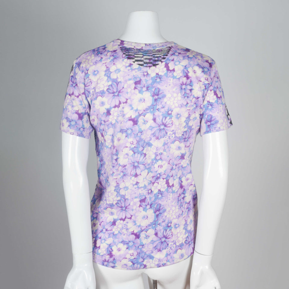 A purple vintage Comme des Garçons floral t-shirt with black geometrical pattern screen printed on the front. 