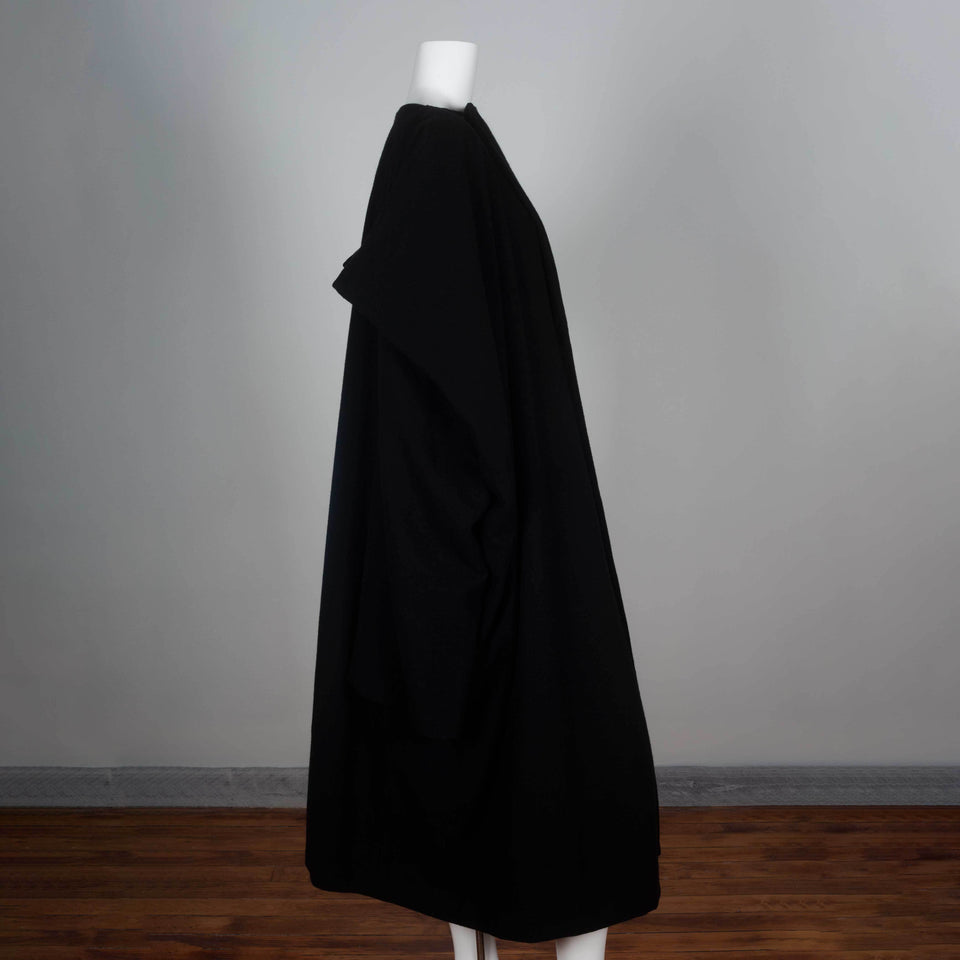 Comme des Garçons 1996 black wool wrap dress from Japan cut in a square with three quarter sleeves and an oversized cape style.