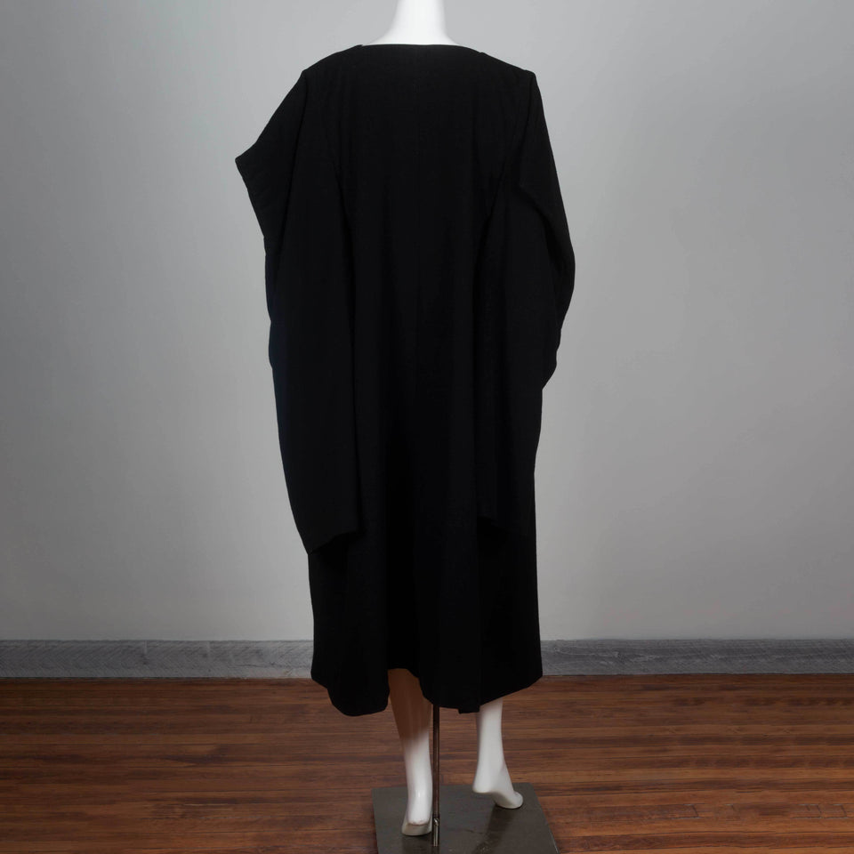 Comme des Garçons 1996 black wool wrap dress from Japan cut in a square with three quarter sleeves and an oversized cape style.