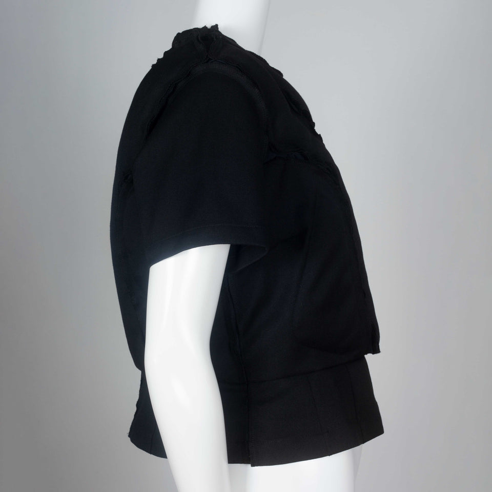 Comme des Garçons 2010 black wool top with padding on chest around collar and on torso.