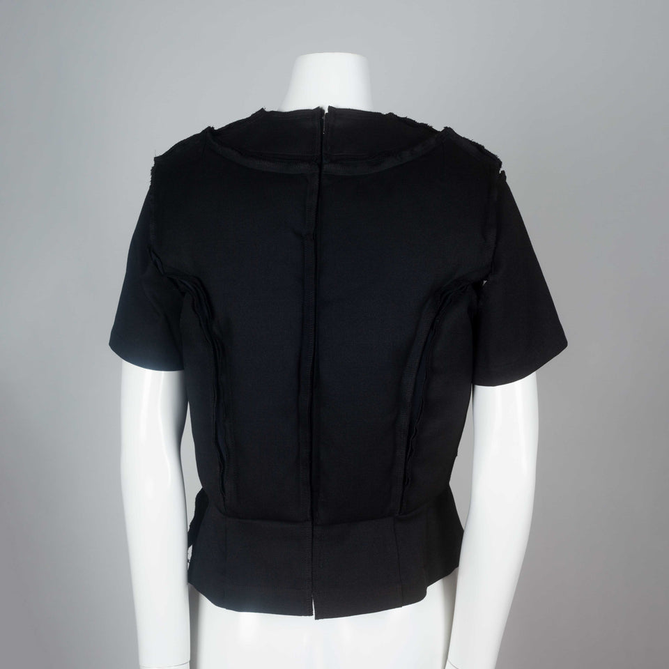 Comme des Garçons 2010 black wool top with padding on chest around collar and on torso.