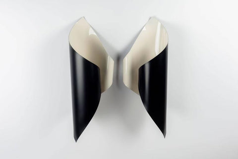Symmetric pair of black and white Mid-Century French wall lights.