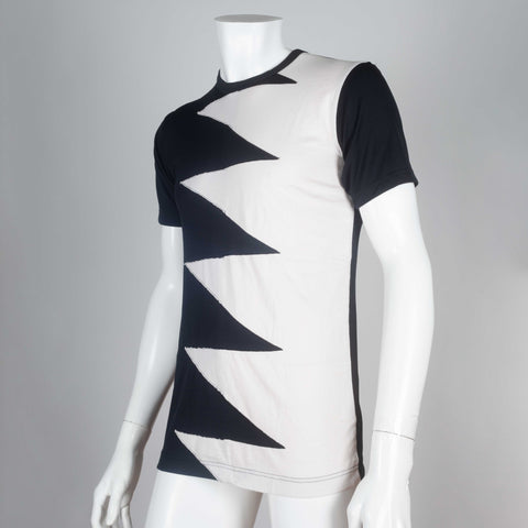 Comme des Garçons black and off-white jersey tee with a lighting bolt zig zag design of interwoven fabric on chest.