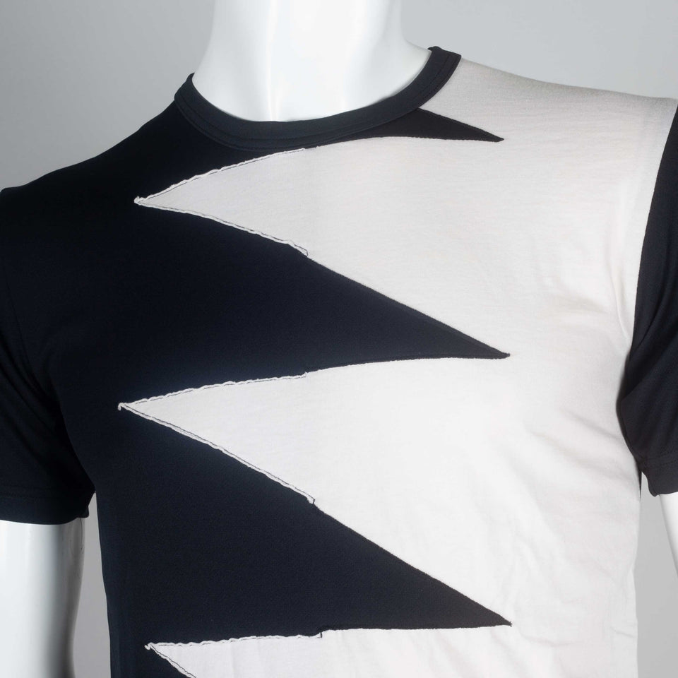 Comme des Garçons black and off-white jersey tee with a lighting bolt zig zag design of interwoven fabric on chest.