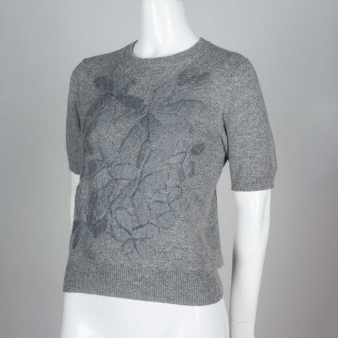 Comme des Garçons gray short sleeve sweater with silk embroidered flowers on front. 