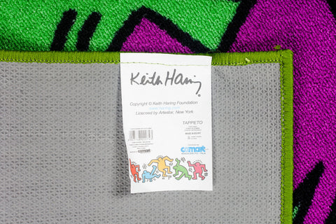 Keith Haring rug tag with Comart, Artestar and Keith Haring Foundation logos. 